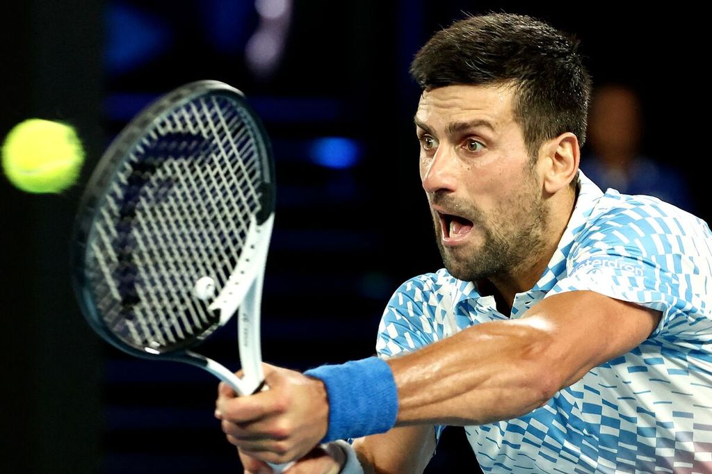 Novak Djokovic memukul bola melawan Andrey Rublev pada laga perempat final tunggal putra Grand Slam Australia Terbuka di Melbourne Park, Melbourne, Australia, Rabu (25/1/2023).