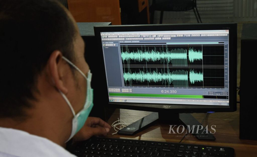 Koordinator restorasi piringan hitam, Pataka Swahara Sanja, mengamati layar monitor komputer saat melakukan digitalisasi piringan hitam di Kantor RRI Surabaya, Jawa Timur, Senin (15/3/2021). Sebagai sumber pengetahuan perkembangan musik Tanah Air, RRI Surabaya kini melakukan digitalisasi koleksi piringan hitam.