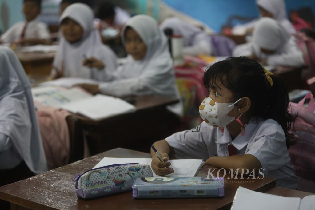 Some students wore masks while participating in class activities on the first day of school after the end of semester holidays and Christmas and New Year's Day at SDN 07 Pondok Kelapa, Jakarta, Monday (2/1/2023). Even though the Government has revoked PPKM status, some students are still disciplined in wearing masks as part of the health protocol.