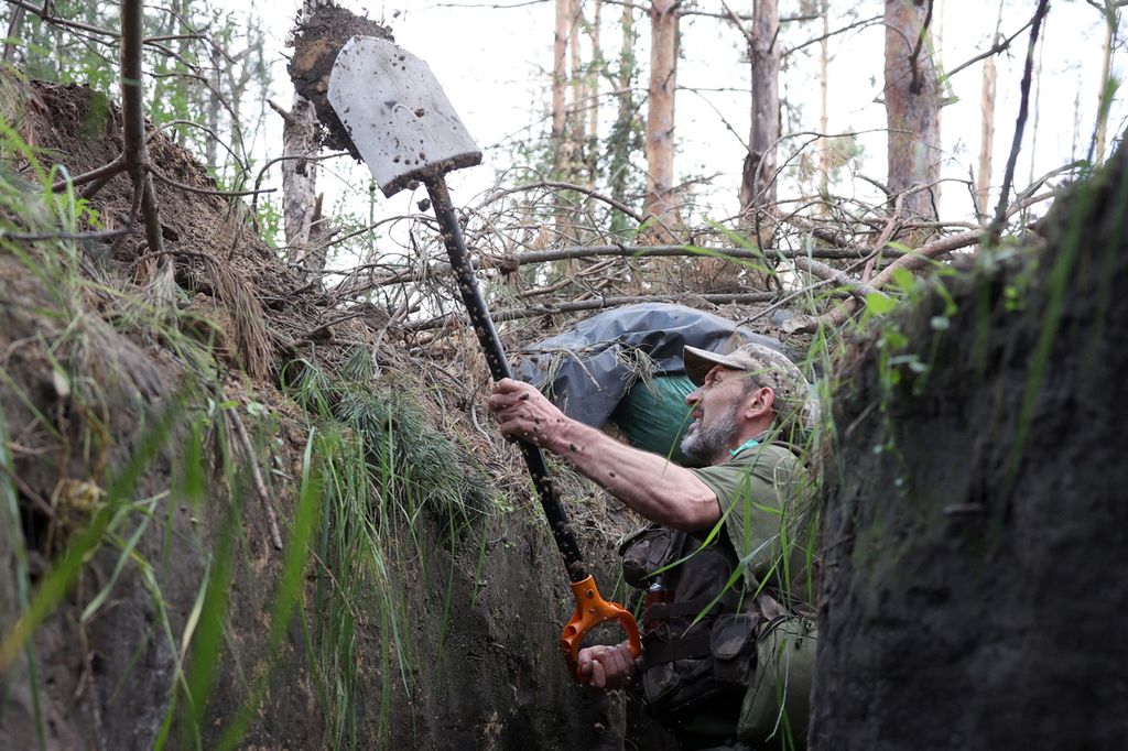 Seorang anggota militer Ukraina menggali parit untuk perlindungan di dekat kota Kreminna, wilayah Lugansk, 17 Juni 2023. Per 20 Juni 2023, Kementerian Pertahanan Ukraina mengklaim telah berhasil membuat kemajuan hingga 4,3 mil ke garis depan dan beberapa wilayah yang dulu sempat dikuasai pasukan Rusia.