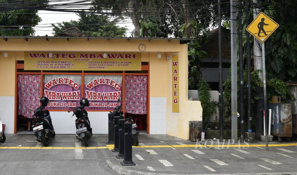 Pemilik warung memasang tirai bergambar Hello Kitty di pintu masuk dan jendela salah satu warung makan di kawasan Cikini, Jakarta, pada hari pertama puasa, Kamis (23/3/2023). 
