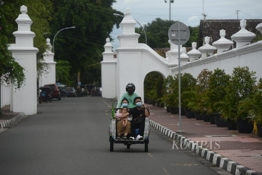 Wisatawan melintas di Jalan Rotowijayan di tepi kompleks Keraton Yogyakarta, Yogyakarta, yang lengang, Senin (4/1/2020). Industri pariwisata Yogyakarta kembali berangsur sepi setelah beberapa hari sebelumnya relatif ramai saat masa libur Natal dan tahun baru. 