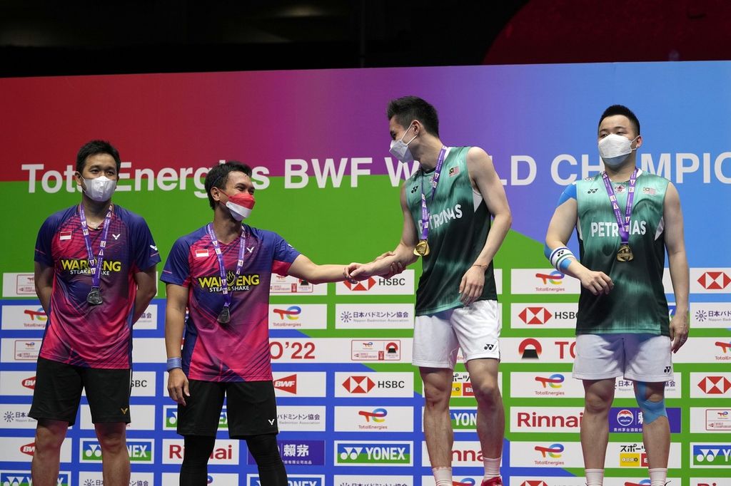 Mohammad Ahsan (kedua dari kiri) memberi selamat kepada pemain ganda Malaysia, Soh Wooi Yik (kedua dari kanan), sebelum upacara pengalungan medali usai laga final Kejuaraan Dunia Bulu Tangkis 2022 di Tokyo Metropolitan Gymnasium, Tokyo, Jepang, Minggu (28/8/2022).