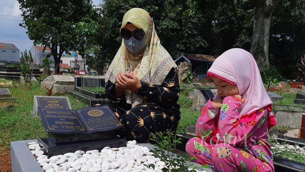 Soliha, resident of Depok, West Java, accompanied by her niece Nai (3 years old) visited the grave of her daughter Azqira, Tuesday (25/10/2022).  Azqira Anindita Nuha died over a week before due to infection of acute kidney injury. 