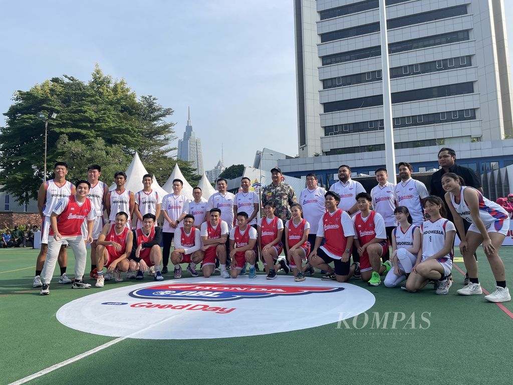 Menteri Pemuda dan Olahraga Dito Ariotedjo dan pendiri sekaligus CEO DBL Indonesia Azrul Ananda berfoto bersama alumni DBL All-Star (jersei merah) dan beberapa pemain DBL All-Star 2023 (jersei putih) dalam peluncuran DBL musim 2023-2024 di Lapangan Plaza Kemenpora, Jakarta, Jumat (14/7/2023).