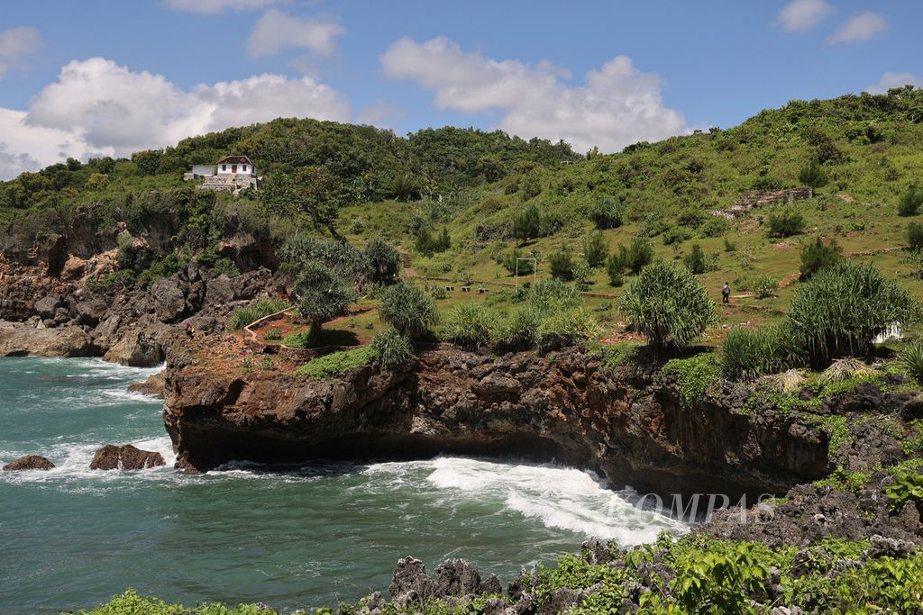 Pengunjung menikmati pemandangan di Pantai Kesirat, Desa Girikarto, Panggang, Gunung Kidul, DI Yogyakarta, Selasa (20/12/2022). Jalan akses menuju pantai itu diperbaiki menggunakan Dana Desa pada tahun 2020 untuk meningkatkan daya tarik wisata tempat tersebut. 