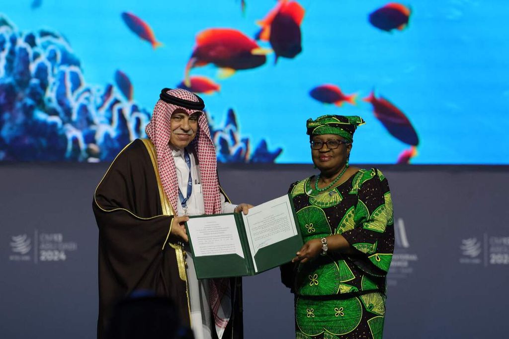 Direktur Jenderal Organisasi Perdagangan Dunia (World Trade Organization/WTO) Ngozi Okonjo-Iweala dan Menteri Perdagangan dan Investasi Arab Saudi Majid al-Qasabi berpose dengan dokumen yang sudah diteken saat sesi Subsidi Perikanan pada Konferensi Tingkat Menteri WTO ke-13 di Abu Dhabi, Uni Emirat Arab, 26 Februari 2024.