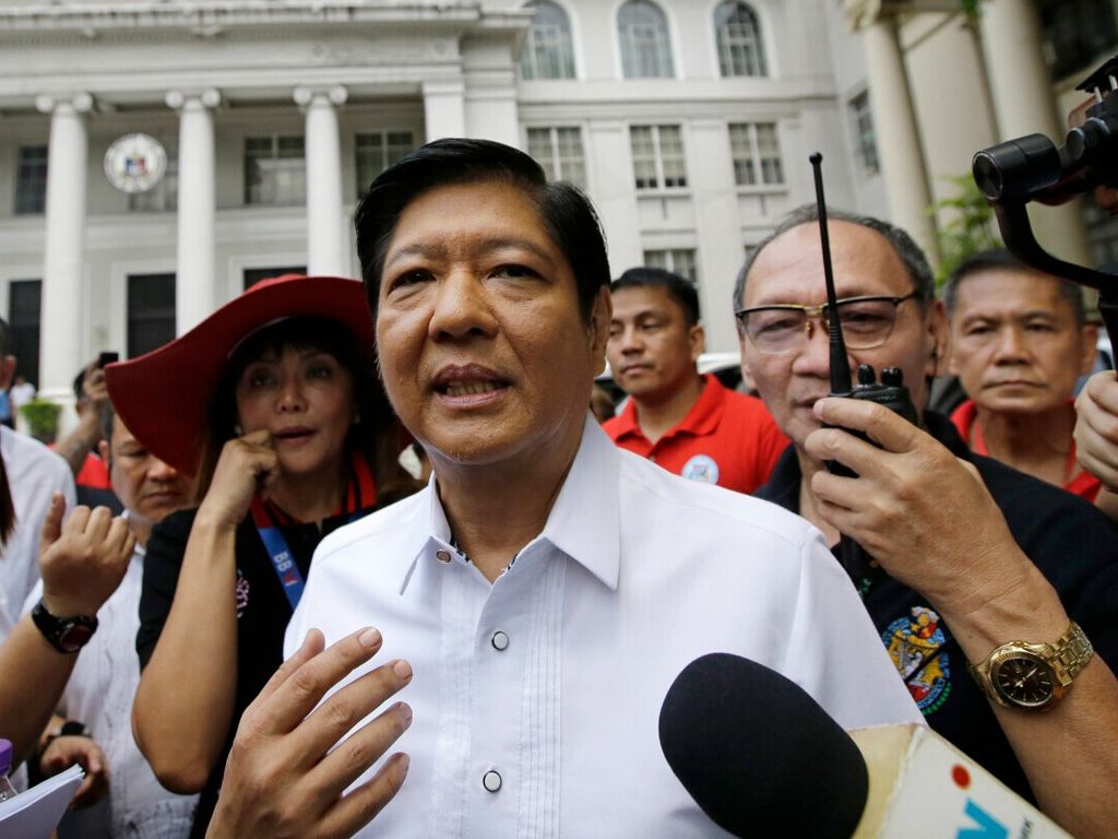 FILE - In this April 2, 2018, file photo, former Senator Ferdinand "Bongbong" Marcos Jr. talks to reporters in front of the Philippine Supreme Court in Manila, Philippines. Marcos Jr., the son and namesake of the late Philippine dictator Ferdinand Marcos, who was toppled in a 1986 revolt, announced Tuesday, Oct. 5, 2021, that he would seek the presidency in next year's elections in what activists say is an attempt to whitewash a dark period in the country's history marked by plunder and human rights atrocities.