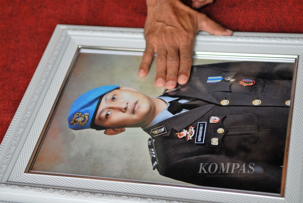 Samuel Hutabarat memegang foto anaknya, Nofriansyah Yosua Hutabarat alias Brigadir J, di Sungai Bahar, Kabupaten Muaro Jambi, Jambi, Sabtu (23/7/2022).