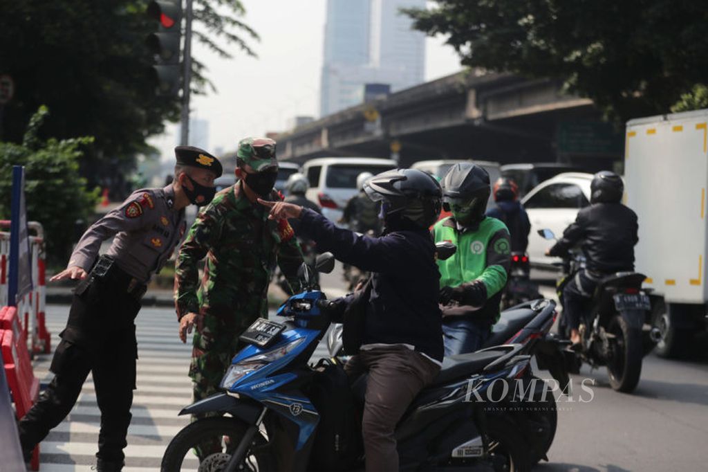 Pengendara bermotor berusaha melobi petugas yang berjaga agar dapat melalui pos penyekatan di Jalan Fatmwati, Jakarta Selatan, Rabu (21/7/2021). Pemerintah memutuskan untuk memperpanjang pemberlakuan pembatasan kegiatan masyarakat (PPKM) darurat hingga 25 Juli 2021. Perpanjangan dilakukan setelah melihat PPKM Darurat yang telah berlangsung selama dua minggu sebelumnya belum dapat menurunkan lonjakan kasus baru Covid-19.