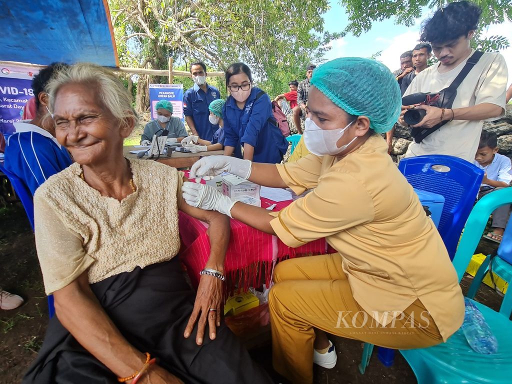 Suasana vaksinasi Covid-19 Inklusif di Kampung Adat Ratenggaro, Desa Maliti Bondo Ate, Sumba Barat Daya, Nusa Tenggara Timur, Minggu (12/3/2023). Tampak seorang perempuan lansia divaksin petugas kesehatan. Program vaksinasi tersebut diselenggarakan oleh Kemitraan Australia-Indonesia untuk Ketahanan Kesehatan (AIHSP) bersama Save the Children dan Circle of Imagine Society Timor menyasar warga lansia, penyandang disabilitas, dan masyarakat adat di wilayah tersebut.