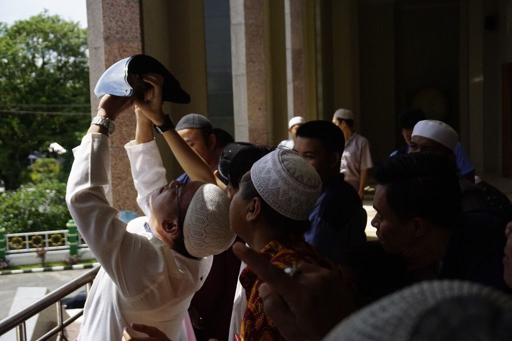 Seusai shalat gerhana, masyarakat menyaksikan fenomena gerhana matahari sebagian di Masjid Agung At Taqwa Balikpapan, Kalimantan Timur, Kamis (26/12/2019). Beberapa masyarakat nekat menggunakan kaca helmet berlapis untuk melihat fenomena alam itu.