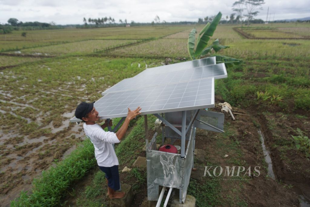 Priyatno (47) memanfaatkan pembangkit listrik tenaga surya untuk menyedot air dari sumur bor di tengah sawah di Desa Kalijaran, Kecamatan Maos, Cilacap, Jawa Tengah, Selasa (11/10/2022). Inovasi itu hadir atas sinergi PT Kilang Pertamina Internasional (KPI) Refinery Unit IV, Pertamina Foundation, serta Politeknik Negeri Cilacap.