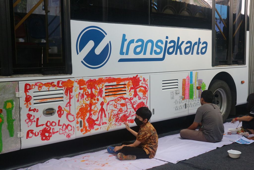 Anak-anak difabel dari komunitas Outsider Art Shop sedang melukis bus Transjakarta dalam kegiatan Transjakarta Melukis bersama Difabel Kantor Pusat PT Transjakarta, Cawang, Jakarta Timur, Kamis (1/12/2022). 