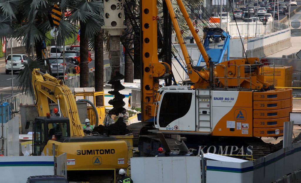 Alat berat mengebor tanah saat proses pembangunan proyek MRT Fase II paket kontrak CP 201 antara Stasiun Thamrin dan Monas di Jalan MH Thamrin, Jakarta Pusat, Minggu (9/5/2020). Kata <i>mengebor</i>, dan bukan <i>membor</i>, merupakan bentuk baku dalam <i>Kamus Besar Bahasa Indonesia</i>.