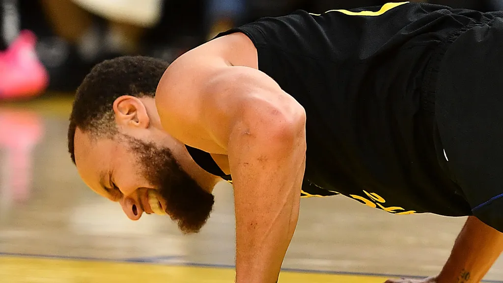 Golden State Warriors' Stephen Curry (30) grimaces in pain after landing on his back during a play in the third quarter of their NBA game at Chase Center in San Francisco, Calif., on Thursday, March 19, 2025. (Jose Carlos Fajardo/Bay Area News Group via AP)