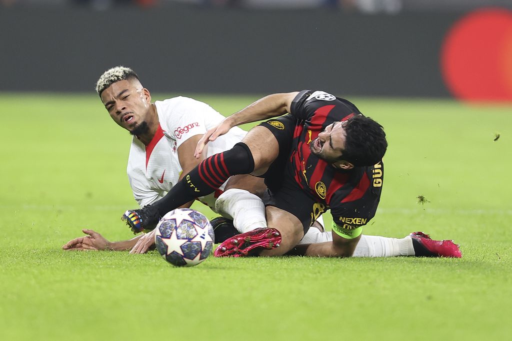 Pemain RB Leipzig, Benjamin Henrichs (kiri), berebut bola dengan gelandang Manchester City, Ilkay Guendogan, pada laga pertemuan pertama babak 16 besar Liga Champions Eropa di Leipzig, Jerman, Kamis (23/2/2023) dini hari WIB. Laga itu berakhir imbang, 1-1.
