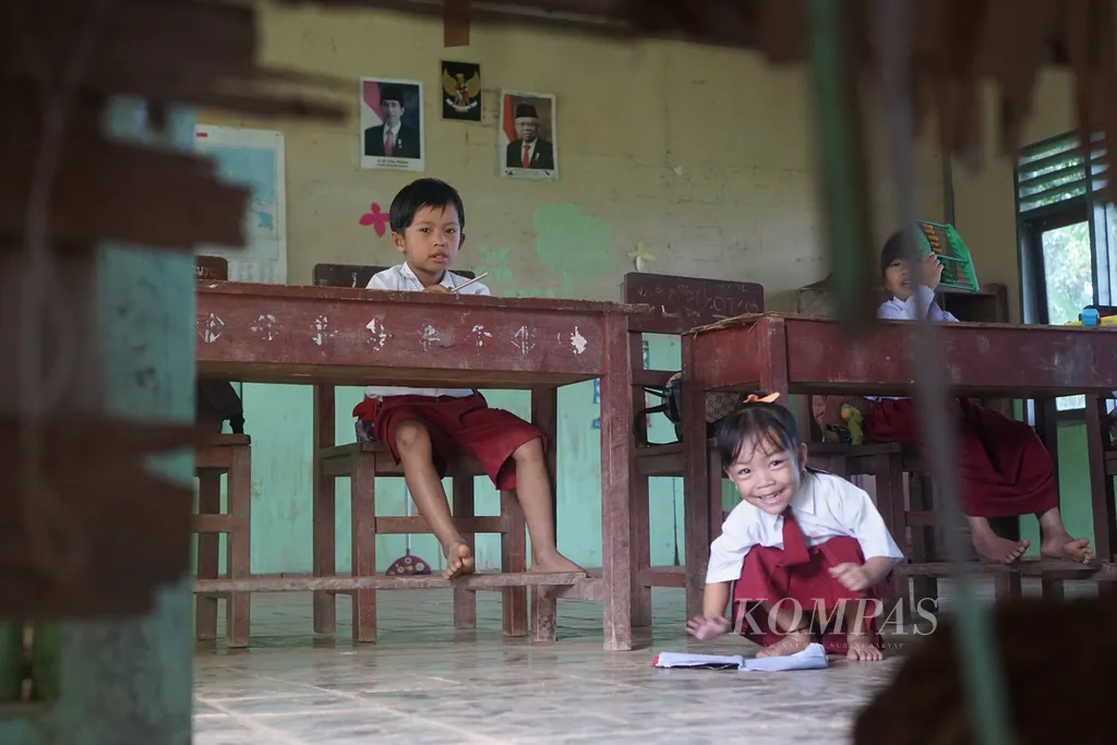 Dari balik tembok triplek yang rusak, terlihat suasana belajar di Sekolah Dasar Kunjung SDN 012 Kampung Mului, Desa Swan Slotung, Kecamatan Muara Komam, Kabupaten Paser, Kalimantan Timur, Senin (20/11/2023).
