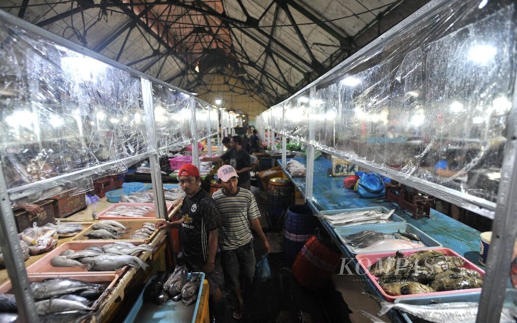 Suasana Pasar Ikan Pabean di Surabaya, Jawa Timur, yang dipasangi pembatas plastik sebagai penerapan protokol kesehatan Covid-19, Rabu (24/6/2020).